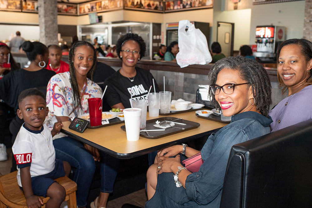 Customers savoring the essence of soul food at our second location in Pearland: Experience the Essence of Soul Food.