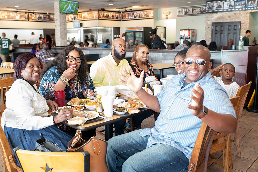 Customers savoring the essence of soul food at our second location in Pearland: Experience the Essence of Soul Food.