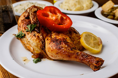 A tantalizing plate of roasted chicken, a highlight from our authentic soul food menu.